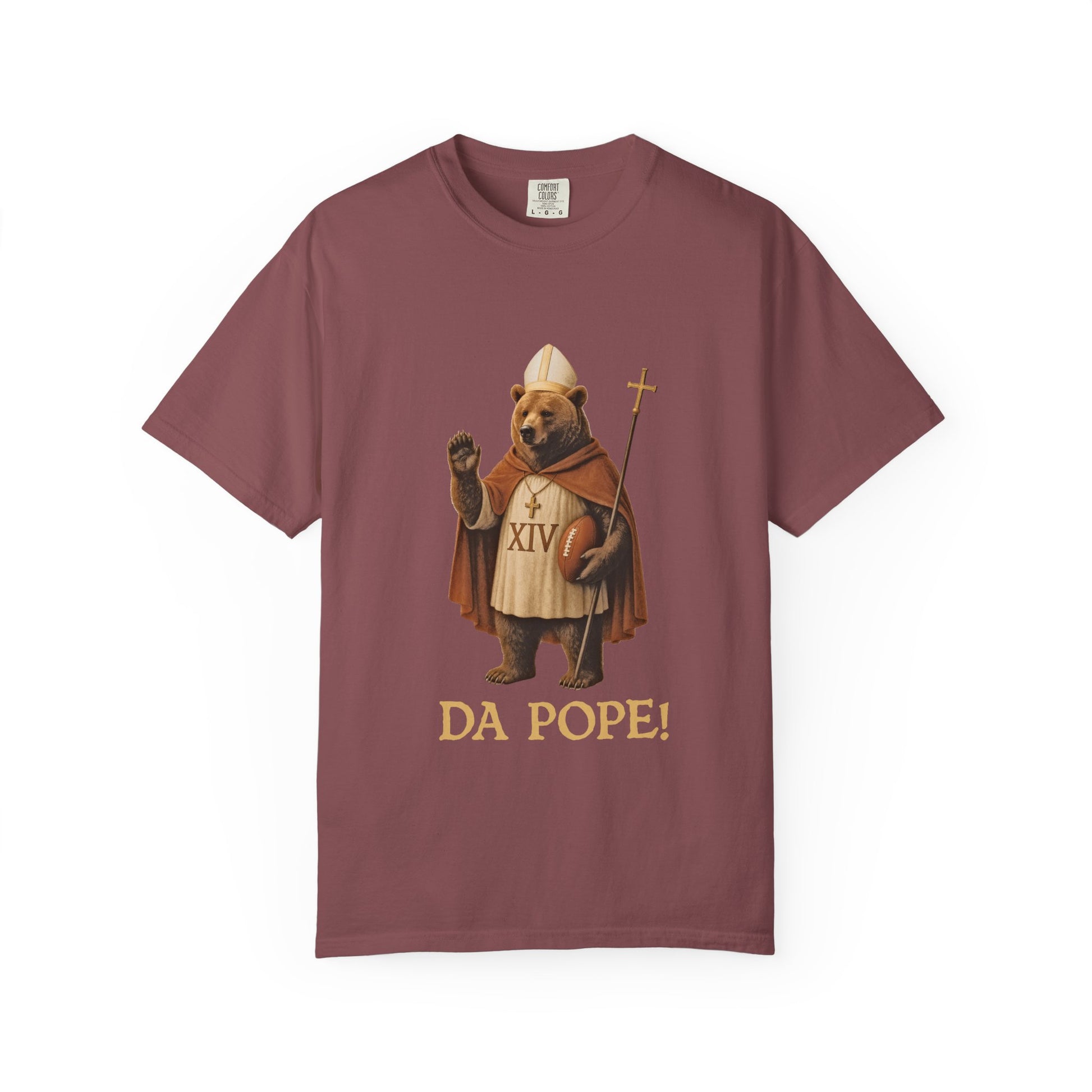 The front side of a brick colored t shirt with a design of a Bear dressed as the pope with the saying DA POPE! below.