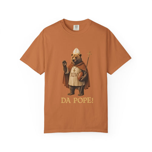 The front side of a burnt orange colored t shirt with a design of a Bear dressed as the pope with the saying DA POPE! below.