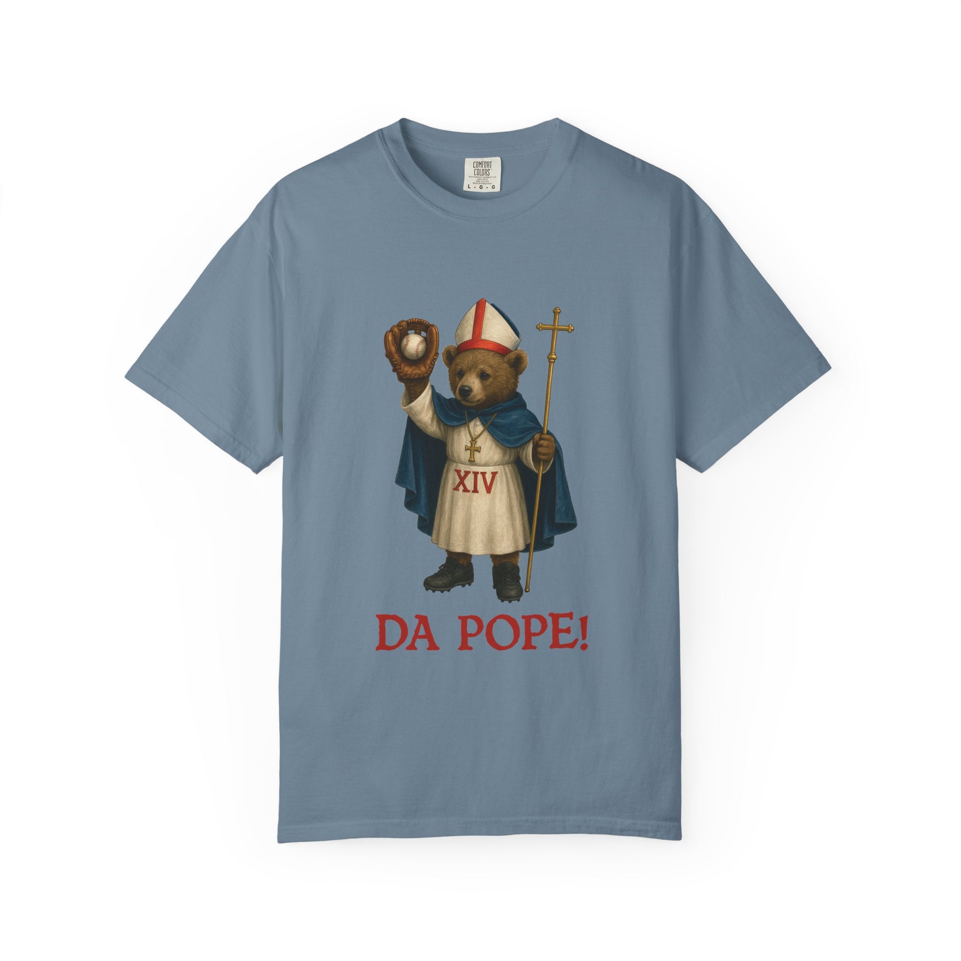 The front side of a ice blue colored t shirt with a design of bear cub dressed as the pope with the saying below saying DA POPE!