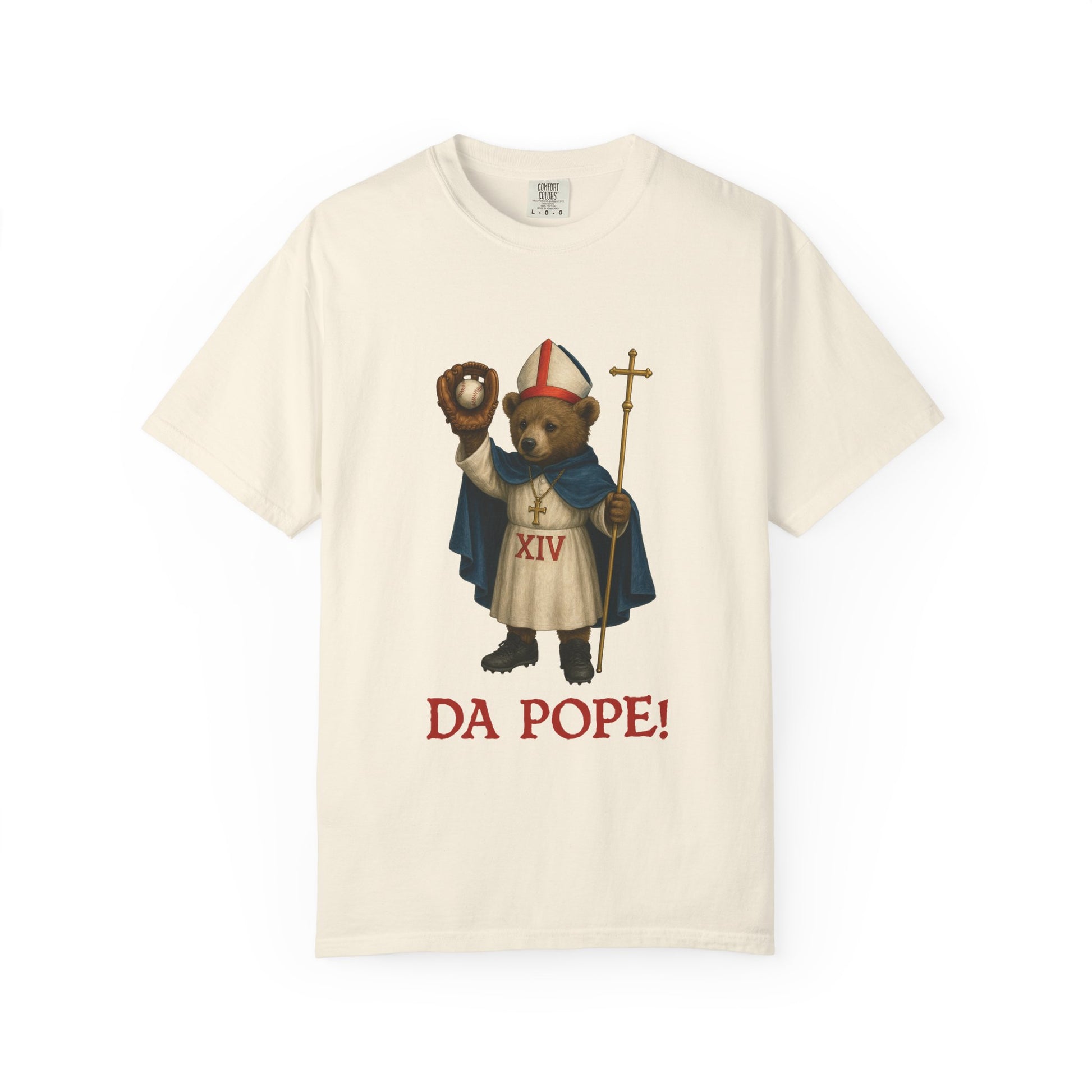 The front side of a ivory colored t shirt with a design of bear cub dressed as the pope with the saying below saying  DA POPE!